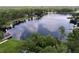 Beautiful aerial image of lakefront homes featuring private docks and scenic wooded surroundings at 5720 Half Moon Lake Rd, Tampa, FL 33625
