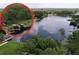 Aerial view showcasing a lakefront property with a private dock and lush greenery surrounding the tranquil waters at 5720 Half Moon Lake Rd, Tampa, FL 33625
