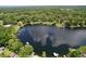 Lake view aerial showcasing lakefront homes with private docks and surrounding trees reflecting the sky at 5720 Half Moon Lake Rd, Tampa, FL 33625