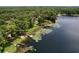 Scenic aerial showcasing a lakefront property with docks, boats, and beautiful lily pads at 5720 Half Moon Lake Rd, Tampa, FL 33625