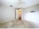 Bedroom with grey walls, ceiling fan, and an open door at 5720 Half Moon Lake Rd, Tampa, FL 33625