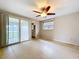 Bedroom with ceiling fan, ensuite bathroom, and sliding glass door access to an enclosed patio at 5720 Half Moon Lake Rd, Tampa, FL 33625
