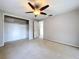 Bedroom with ceiling fan, closet, and natural light at 5720 Half Moon Lake Rd, Tampa, FL 33625