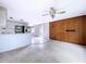 Open living area flows into kitchen, featuring stainless appliances and ample counter space at 5720 Half Moon Lake Rd, Tampa, FL 33625
