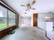 Bright living room flowing into kitchen, offering backyard and lake views from the large windows at 5720 Half Moon Lake Rd, Tampa, FL 33625