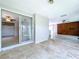 Enclosed patio features tile flooring and sliding glass doors to the backyard and adjacent room at 5720 Half Moon Lake Rd, Tampa, FL 33625