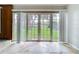 Bright sunroom with tile floors, large glass doors and lawn views at 5720 Half Moon Lake Rd, Tampa, FL 33625