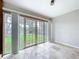 Bright sun room with tile flooring and glass doors leading to the backyard at 5720 Half Moon Lake Rd, Tampa, FL 33625