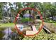 Lovely waterfront property with a dock, lush trees, and tranquil water views, ideal for relaxation and water activities at 5720 Half Moon Lake Rd, Tampa, FL 33625