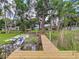 Beautiful waterfront property featuring a dock and lush trees, perfect for lakeside living and enjoying nature's tranquility at 5720 Half Moon Lake Rd, Tampa, FL 33625
