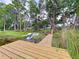 Picturesque waterfront property with a wooden dock and vibrant greenery, offering a serene and inviting lakeside retreat at 5720 Half Moon Lake Rd, Tampa, FL 33625