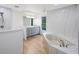 Bright bathroom features a soaking tub, double vanity, and sleek finishes at 5933 Carina Trce, Wesley Chapel, FL 33545