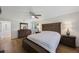 Relaxing bedroom featuring hardwood floors, a ceiling fan, and ample natural light for a serene atmosphere at 5933 Carina Trce, Wesley Chapel, FL 33545