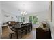 Elegant dining room featuring a large table, stylish chairs, and a modern chandelier for Gathering meals at 5933 Carina Trce, Wesley Chapel, FL 33545