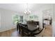 Elegant dining room featuring a large table, stylish chairs, and a modern chandelier at 5933 Carina Trce, Wesley Chapel, FL 33545