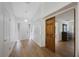 Bright foyer with hardwood floors, a modern light fixture, and a view into the adjacent room at 5933 Carina Trce, Wesley Chapel, FL 33545