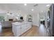 Open floor plan showcasing kitchen with a large center island and stainless steel appliances at 5933 Carina Trce, Wesley Chapel, FL 33545