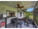 Comfortable screened porch with seating, a ceiling fan, and an outdoor view at 5933 Carina Trce, Wesley Chapel, FL 33545