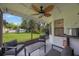 Inviting screened-in porch with comfortable seating overlooking a lush, green backyard at 5933 Carina Trce, Wesley Chapel, FL 33545