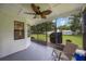 Relaxing screened porch offers view of well-maintained yard with a storage shed at 5933 Carina Trce, Wesley Chapel, FL 33545