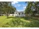 Exterior view of a backyard storage shed with a door and windows in a grassy yard at 5933 Carina Trce, Wesley Chapel, FL 33545