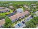 Aerial view of a well-maintained townhome community with a pond and mature trees at 6109 Bayside Key Dr, Tampa, FL 33615