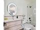 This bathroom has a shower and tub, modern vanity, and a circular mirror at 6109 Bayside Key Dr, Tampa, FL 33615