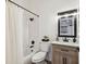 This bathroom has a shower and tub, modern vanity, and black fixtures at 6109 Bayside Key Dr, Tampa, FL 33615