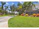 Community entrance featuring beautiful landscaping, a stone wall, and 'The Villages of Bayport' sign at 6109 Bayside Key Dr, Tampa, FL 33615