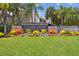 Inviting community entrance with lush landscaping, colorful plants and clear signage at 6109 Bayside Key Dr, Tampa, FL 33615