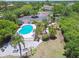 Aerial view of a community pool area featuring lounge chairs, palm trees, and shady spots at 6109 Bayside Key Dr, Tampa, FL 33615