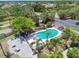 Aerial view of a community pool surrounded by palm trees and lounge chairs at 6109 Bayside Key Dr, Tampa, FL 33615