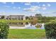 Beautiful exterior view of townhomes reflected in a peaceful pond surrounded by lush greenery at 6109 Bayside Key Dr, Tampa, FL 33615