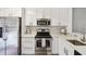 Modern kitchen with stainless steel appliances and sleek white cabinetry at 6109 Bayside Key Dr, Tampa, FL 33615