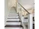Staircase leads to a modern kitchen and dining area, adding to the home's open and connected feel at 6109 Bayside Key Dr, Tampa, FL 33615
