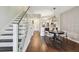 Open living space with staircase featuring glass railing and hardwood floors throughout the home at 6109 Bayside Key Dr, Tampa, FL 33615