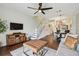 Bright open concept living space features stairs with glass railing and modern furnishings at 6109 Bayside Key Dr, Tampa, FL 33615