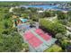 Aerial view of community tennis courts and pool area surrounded by lush greenery at 6109 Bayside Key Dr, Tampa, FL 33615