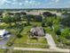 Expansive aerial view of a beautiful home with a large yard, pool, and surrounding greenery at 611 Robinson Oaks Ln, Plant City, FL 33567