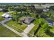 Aerial view of a charming single-Gathering home with a spacious yard and long driveway surrounded by mature trees at 611 Robinson Oaks Ln, Plant City, FL 33567