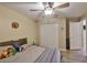 This bedroom features a ceiling fan, closet, and wood-look flooring at 611 Robinson Oaks Ln, Plant City, FL 33567