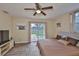 Bedroom featuring a ceiling fan, pool views, and wood-look flooring at 611 Robinson Oaks Ln, Plant City, FL 33567