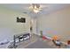 Bright bedroom featuring a ceiling fan, neutral walls, and modern flooring at 611 Robinson Oaks Ln, Plant City, FL 33567