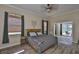 Stylishly decorated bedroom with hardwood floors, a ceiling fan, and natural light at 611 Robinson Oaks Ln, Plant City, FL 33567