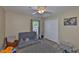 Cozy bedroom with a gray futon, gray and white rug, and a closet at 611 Robinson Oaks Ln, Plant City, FL 33567