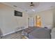 This is a cozy bedroom with a flat screen TV, a bench, and an archway to the bathroom at 611 Robinson Oaks Ln, Plant City, FL 33567