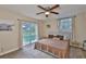 Bedroom with view of the screened pool area and sliding glass doors at 611 Robinson Oaks Ln, Plant City, FL 33567
