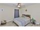 Bedroom features a plush queen bed, a nightstand, and a large window with curtains at 611 Robinson Oaks Ln, Plant City, FL 33567