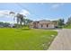 Charming single-story home with lush green lawn, mature trees, and a long driveway at 611 Robinson Oaks Ln, Plant City, FL 33567