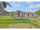 Charming single-story home with a well-manicured lawn and mature trees at 611 Robinson Oaks Ln, Plant City, FL 33567